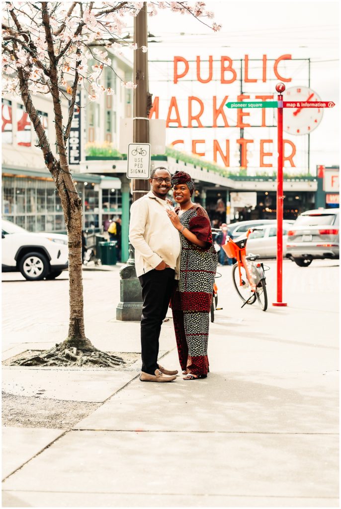 Black couple at engagement session at pike place market in downtown seattle, captured by candace photographyy