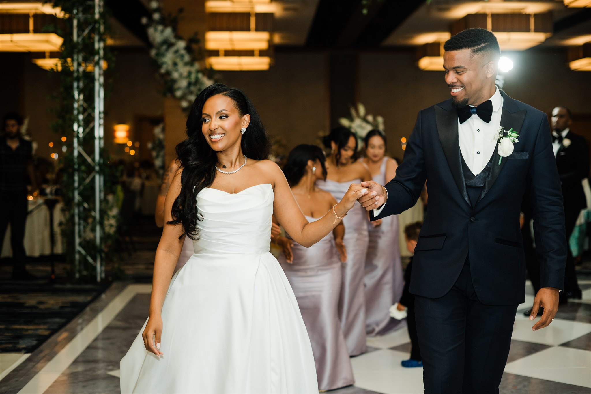 Bride and groom walking hand in hand during a traditional wedding ceremony at the Hyatt Bellevue, photographed as part of a two-day cultural wedding celebration.