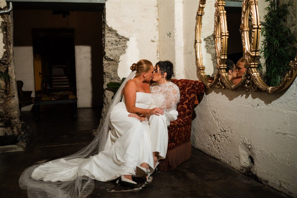 Intimate wedding portrait of a couple seated together at The Press Room in Tacoma with moody evening light