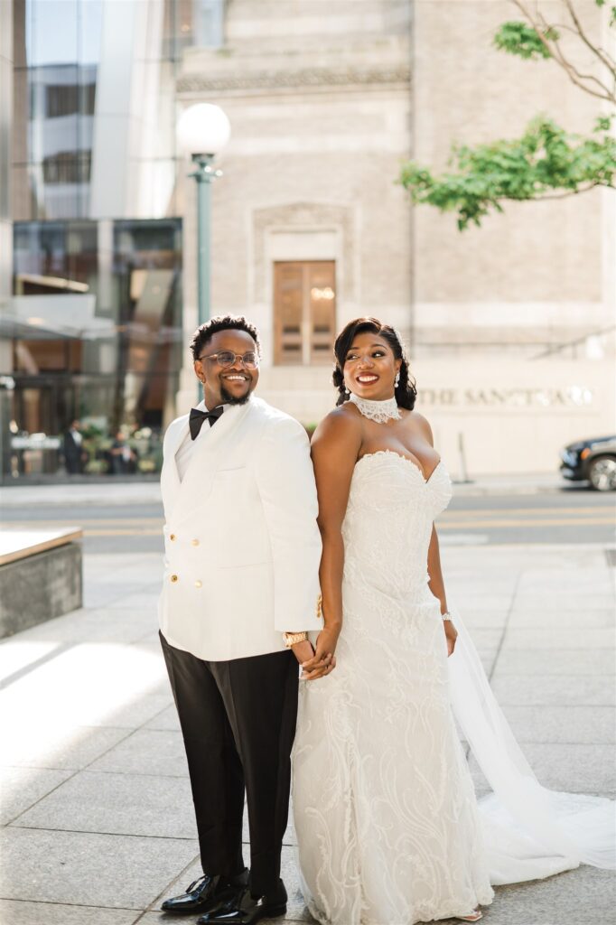 Wedding portraits outside Lotte Hotel Seattle featuring a modern city backdrop