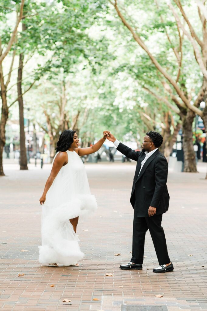 Black couple dancing at Occidental Square Pioneer Square Seattle engagement photos