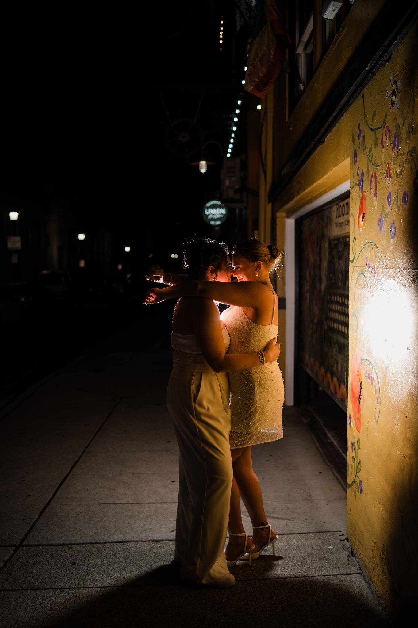 Brides Embrace at End of Night Outside of Wedding Venue