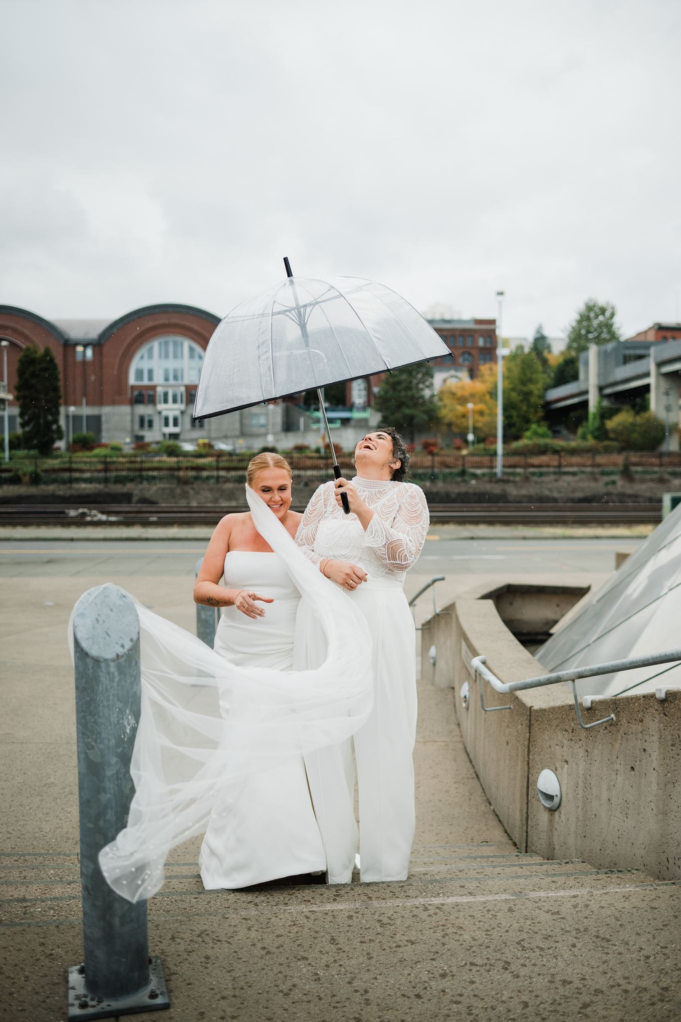 Brides Laughing as Veil Gets Caught on Railing During Wind Storm