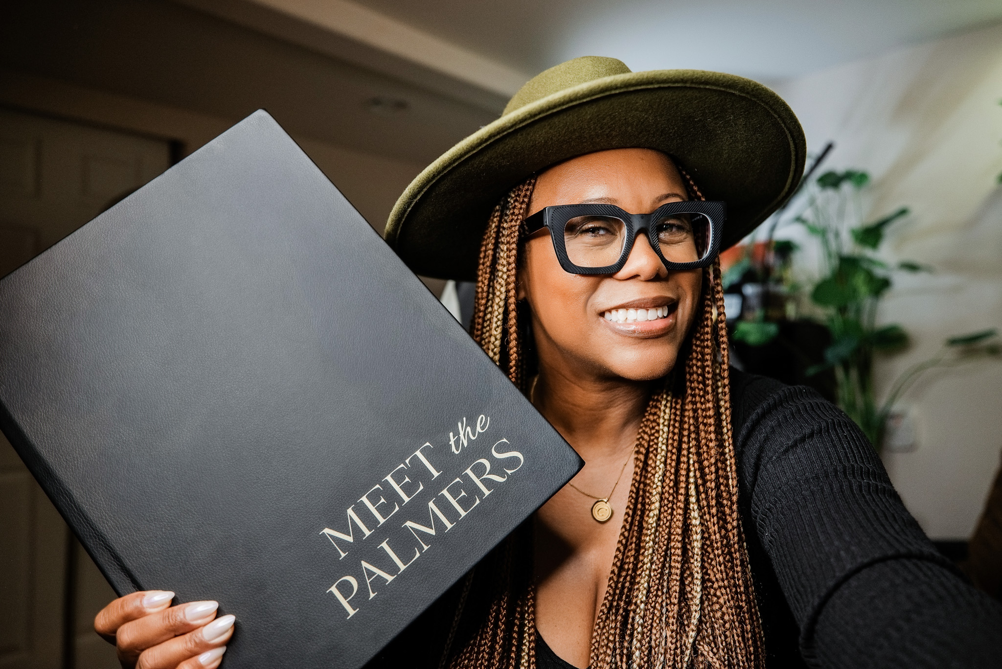 Seattle wedding photographer Candace Connor holding a DreambooksPro wedding album designed in SmartAlbums