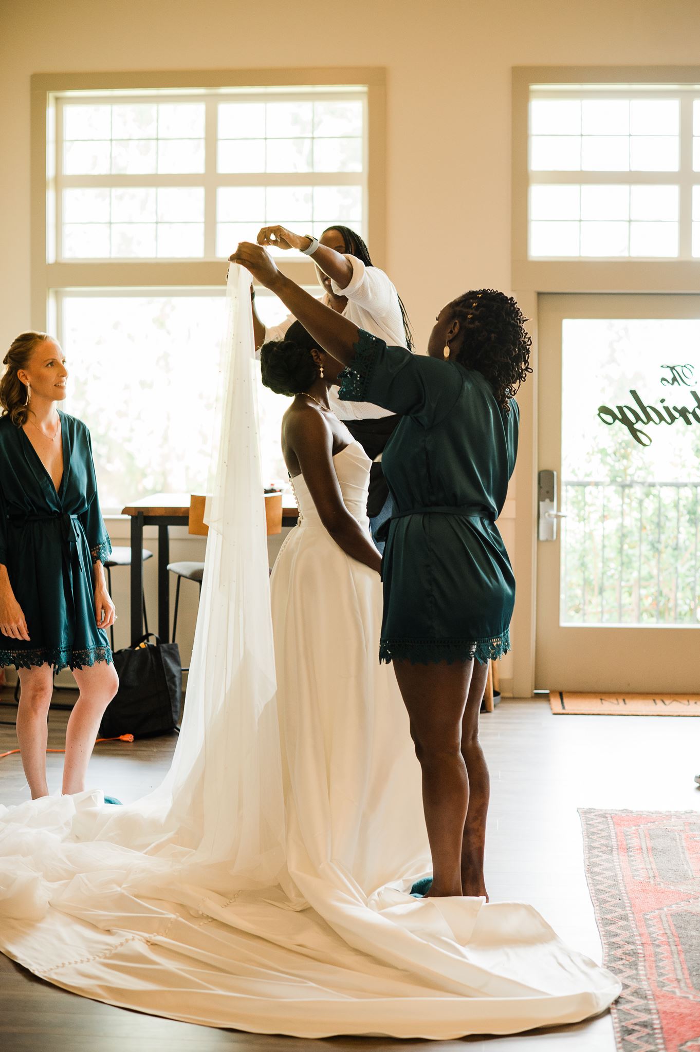 Bridal Party Puts Veil on Bride in Getting Ready Suite