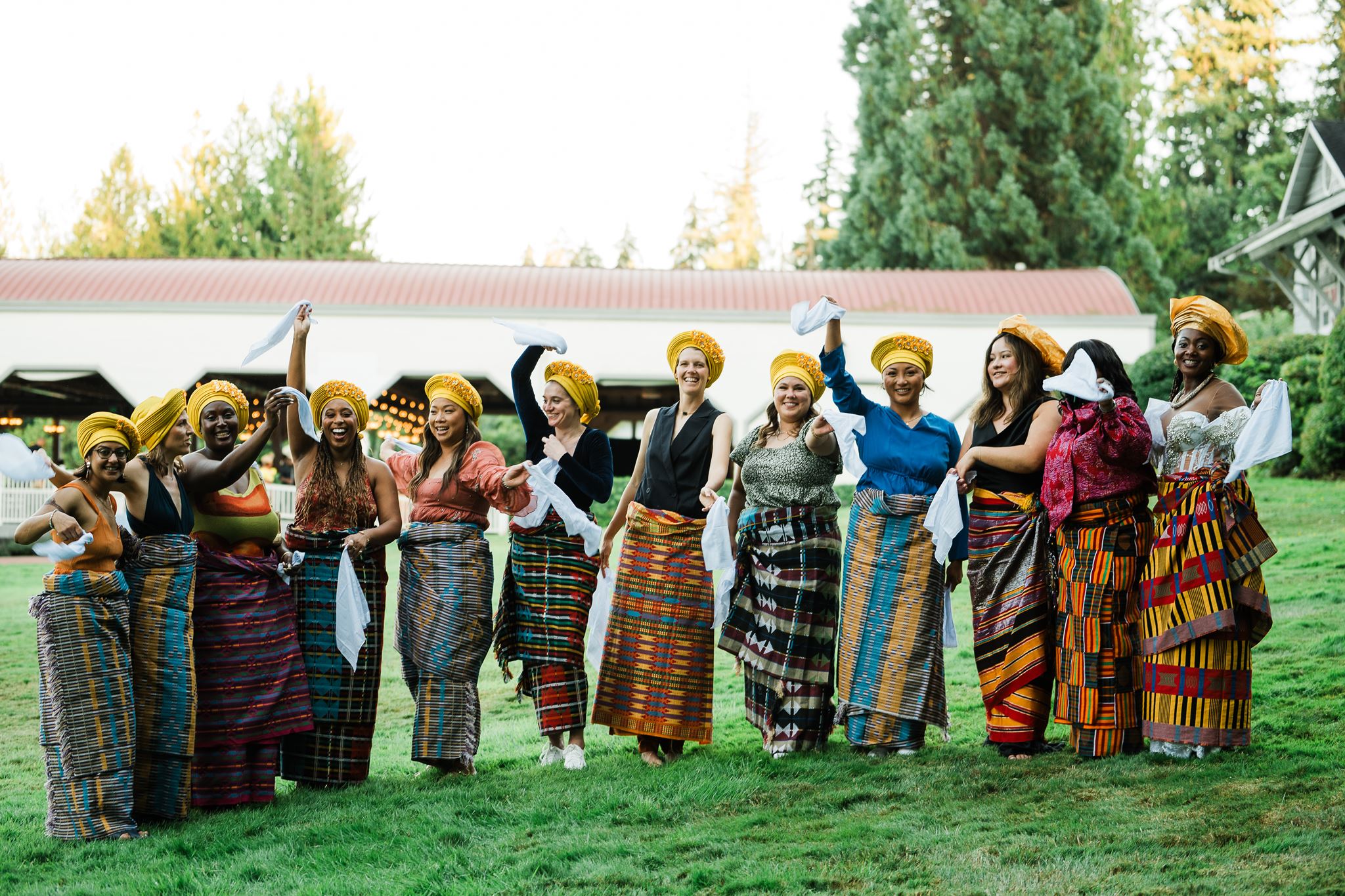 Guests Wearing Traditional Nigerian Head Wraps, Waving Handkerchiefs in the air