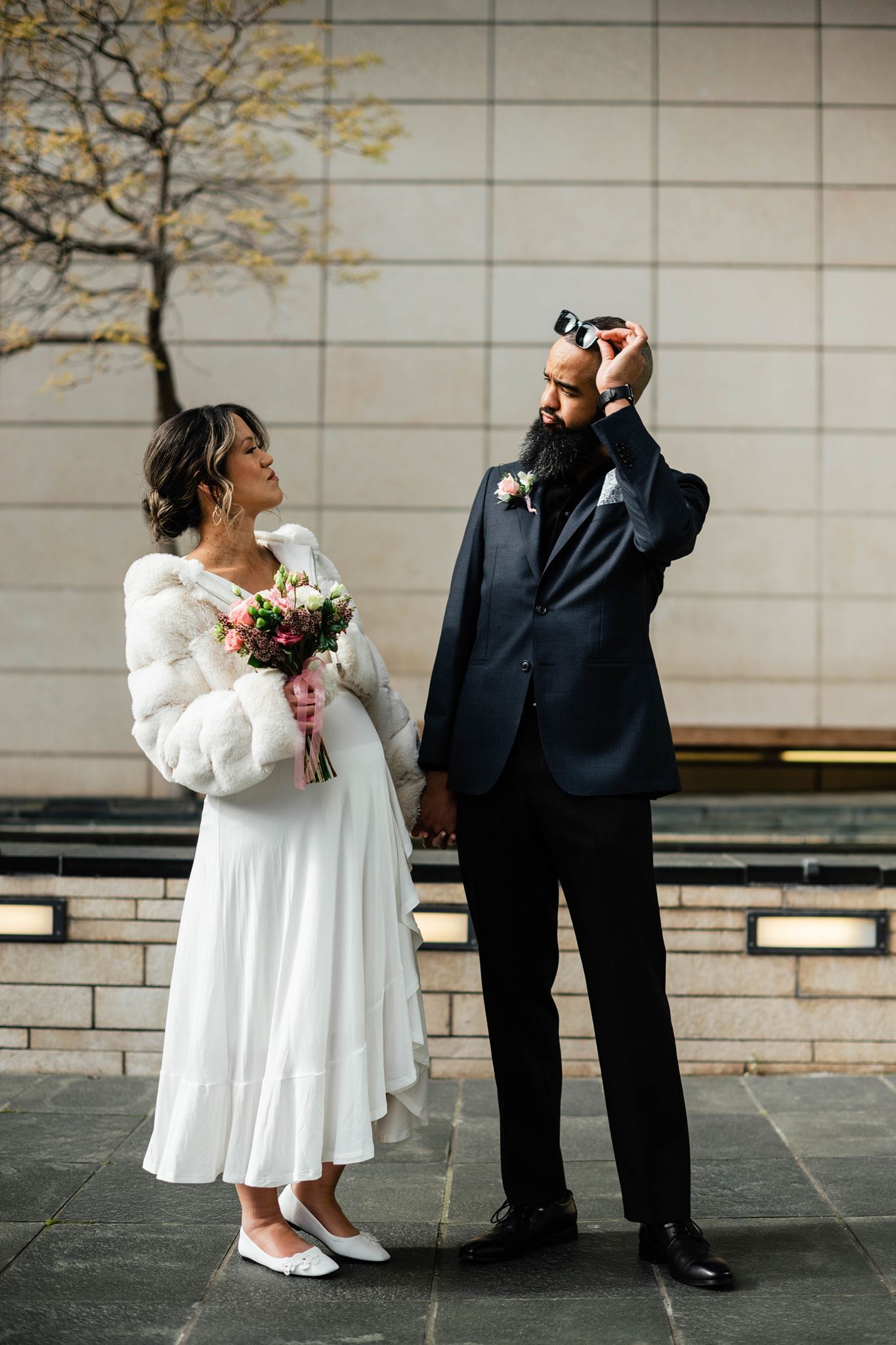 Couple Smile at Each Other as They Walk to Seattle Courthouse Wedding
